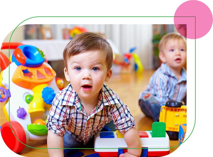 Two young boys playing with toys in a room.